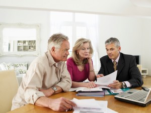 Couple With Financial Advisor At Table